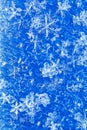 Blue white winter background from snowflakes blur