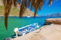 Blue and white wooden boat in cosy Greek port