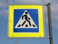 Blue, white and yellow pedestrian crossing sign on the sky background Royalty Free Stock Photo