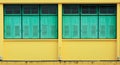 Blue window at antique yellow concrete building. Royalty Free Stock Photo