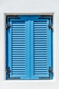 Blue window with Bahama shutters