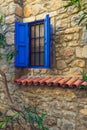 Blue window in an old stone house Royalty Free Stock Photo