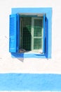 Blue window with shutters on Greek Island Royalty Free Stock Photo