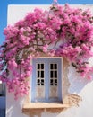 blue window of typical white house in greek island, pink bougainvillea in santorini