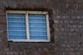 Blue window on an unfinished brick wall vintage look Royalty Free Stock Photo