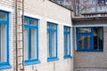 Blue windows of brick building and staircase to roof Royalty Free Stock Photo