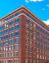 Blue Windows in Corner of Old Brick Building Royalty Free Stock Photo