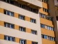 Blue windows on newly restored concrete tower apartment buiding