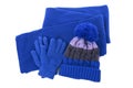 Blue winter knitted bobble hat, scarf gloves isolated white background Royalty Free Stock Photo