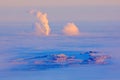 Blue winter landscape, smoke from factory, ice and rime. Pink morning light before sunrise. Winter twilight, cold nature in forest Royalty Free Stock Photo