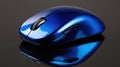 Blue wireless computer mouse reflecting on dark surface Royalty Free Stock Photo
