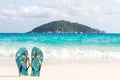 Blue women`s beach shoes, with white sand, blue sea and sky. Thailand, Similan Islands. Royalty Free Stock Photo