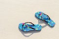 Blue women`s beach shoes, with white sand, blue sea and sky. Thailand, Similan Islands. Royalty Free Stock Photo