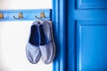Blue women's slippers in Greek style of house on Royalty Free Stock Photo