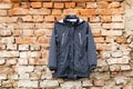 Blue womens jacket weighs on hangers on the wall at home outdoors, womens jacket