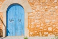 Blue wood door and rustic stone wall of mediterranean house Royalty Free Stock Photo