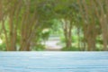 blue wood table top on blur green alley of trees background Royalty Free Stock Photo