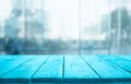 Blue wood table top on blur window glass,wall background