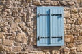 Blue wood window at old rustic wall Royalty Free Stock Photo