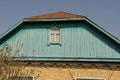 blue wooden attic with a small window of an old rural brown house Royalty Free Stock Photo