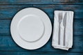 Blue wooden background and empty plate with cutlery Royalty Free Stock Photo