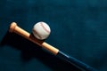 Blue wooden baseball bat and a baseball ball on blue background Royalty Free Stock Photo