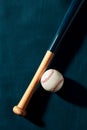 Blue wooden baseball bat and a baseball ball on blue background Royalty Free Stock Photo