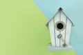 Blue wooden bird house with a metal key on a blue and green back Royalty Free Stock Photo