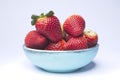 Blue wooden bowl filled with strawberries Royalty Free Stock Photo