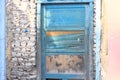 Blue wooden door in a stone wall of an abandoned pink house Royalty Free Stock Photo