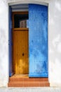 Blue wooden door on white wall background. Front view of mediterranean village. Traditional architecture Royalty Free Stock Photo