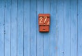 Blue wooden fence with mailbox in the foreground Royalty Free Stock Photo