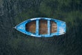 Blue wooden fishing boat anchored in the sea, top view Royalty Free Stock Photo