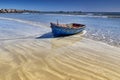 A blue wooden fishing boat on a golden sandy beach in Paternoster on the west coast of South Africa. Royalty Free Stock Photo