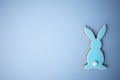 Blue wooden flat easter bunny lies on a blue