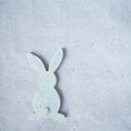 Blue wooden flat easter bunny lies on a blue