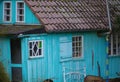 Cute old wooden house in light blue with red roof tiles Royalty Free Stock Photo