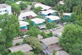 Blue wooden houses, many gray roofs in the same community in the provinces, have trees around, looking from wide-angle,