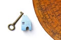 Blue wooden miniature house and antique key with old Chinese Feng Shui compass plate Royalty Free Stock Photo