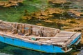 Blue wooden row boat floating on water Royalty Free Stock Photo