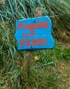 Blue wooden sign, penguin can peck, in dutch language Royalty Free Stock Photo