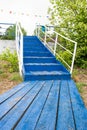 Blue wooden staircase up . white wooden railing. Royalty Free Stock Photo