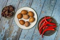 Blue wooden table with cooking ingredients, brown eggs, hot red pepper Royalty Free Stock Photo