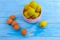 On a blue wooden table a plate with fresh pears and walnuts Royalty Free Stock Photo