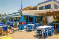 Blue wooden tables and chairs in Greek restaurant