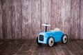 Blue wooden toy car on a wooden background. Royalty Free Stock Photo