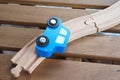 Blue wooden toy car on tracks on a wooden surface Royalty Free Stock Photo