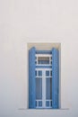 Blue wooden window against white wall backgrounds of traditional Greek Island buildings Royalty Free Stock Photo