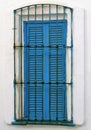 Blue wooden window in white house Royalty Free Stock Photo