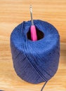 Blue wool bud with pink crochet hook